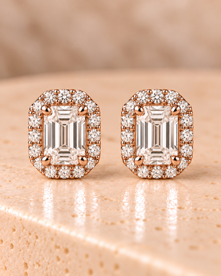 Front view of emerald halo diamond stud earrings in rose gold