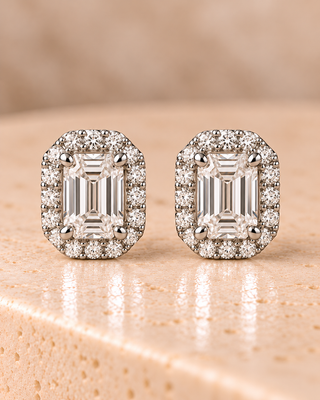 Front view of emerald halo diamond stud earrings in white gold