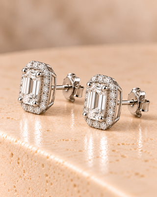Side view of emerald halo diamond stud earrings in white gold