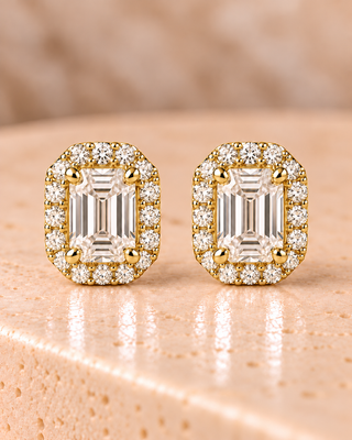 Front view of emerald halo diamond stud earrings in yellow gold