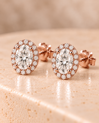 Tilt view of oval halo diamond stud earrings in rose gold