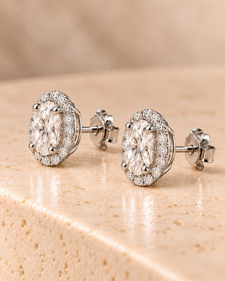 Side view of oval halo diamond stud earrings in white gold