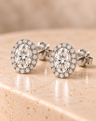 Tilt view of oval halo diamond stud earrings in white gold
