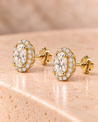 Side view of oval halo diamond stud earrings in yellow gold