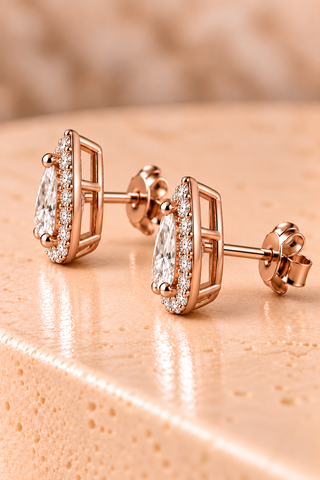 Side view of pear halo diamond stud earrings in rose gold