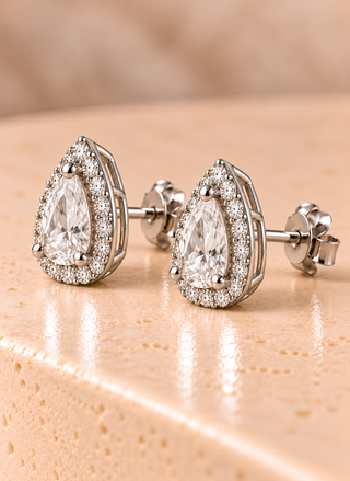 Side view of pear halo diamond stud earrings in white gold