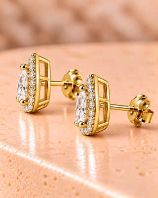 Side view of pear halo diamond stud earrings in yellow gold